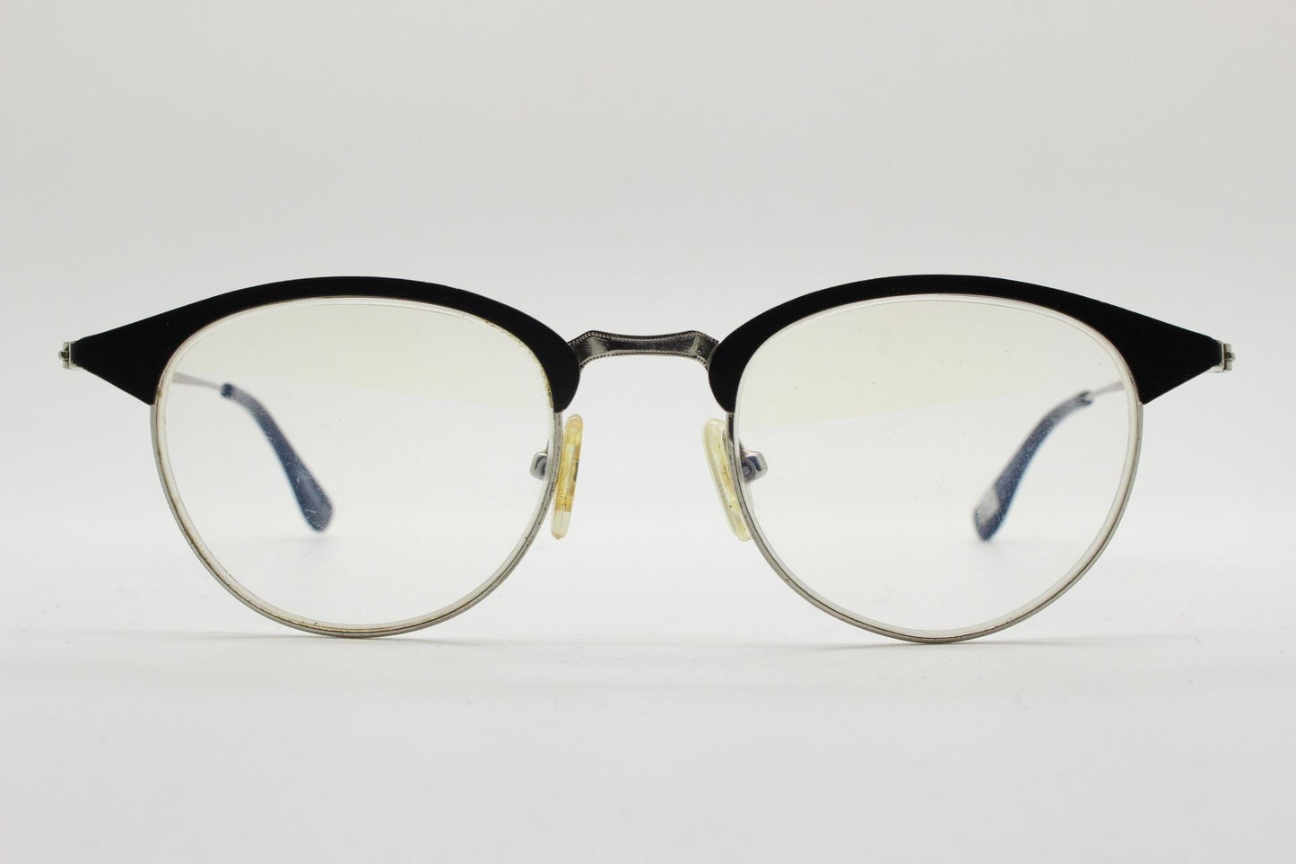 Lupo and Co round eye glasses with pointed corners. Flat metal silver optical frames with black browline. Prescription eyeglasses. RX