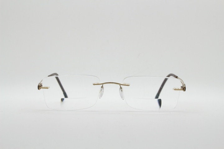 Silhouette rectangular frameless eye glasses model 7677 made in Austria. Minimal lightweight optical frame with golden trim. Prescription RX