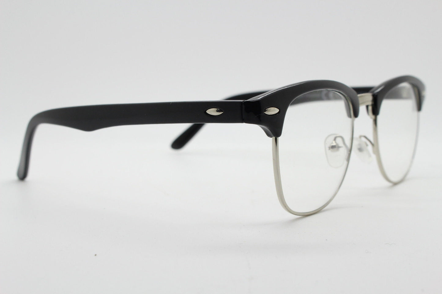 90s vintage black half frame eye glasses. Black gloss browline with silver wire rim frame and clear lenses. Classic 50s, 60s design. NOS