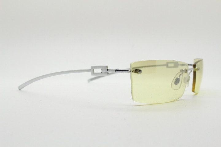 Y2K vintage rectangular sunglasses. Minimal frameless light tone curved mirrored lenses with silver chrome trim. 2000's. 90s. 00s. NOS