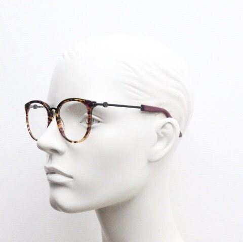 Kenzo vintage round eye glasses made in France. Tortoise with purple tones and matching arm sections. Womens Prescription Optical frames. RX
