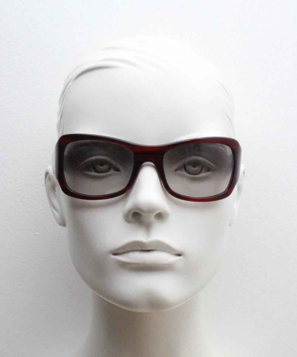 Y2k vintage wrap around large bug eye sunglasses. Curved red acetate shield frame with light tone lenses. 1960s bug eye design. 2000's NOS
