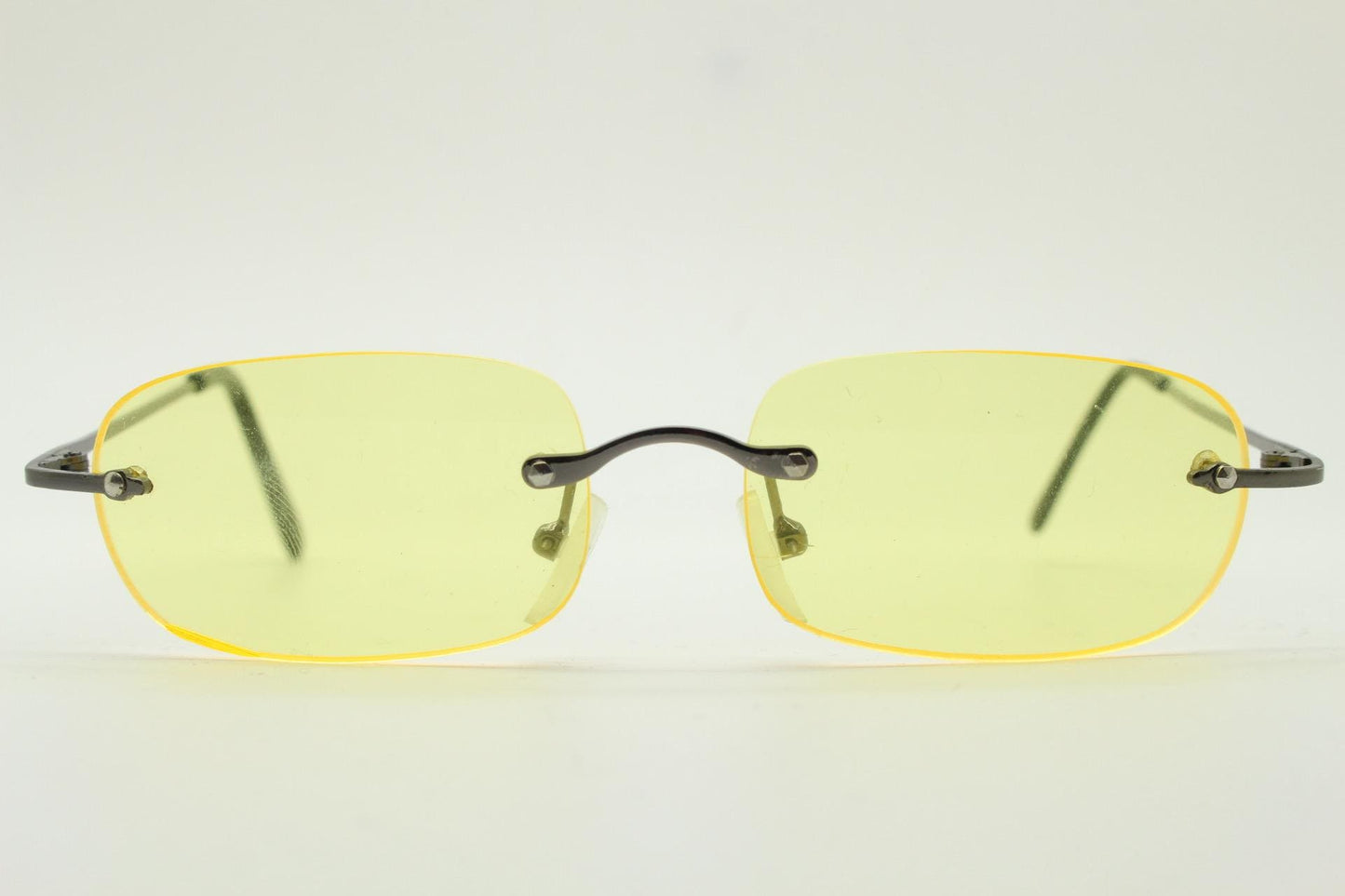 Y2K vintage frameless yellow sunglasses. Rectangular lenses with grey metal bridge and arms. 2000s club kids. 00's. 90s Rave