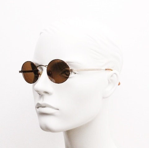 Armandos 90s vintage oval sunglasses made in Italy. Enamelled honey tortoise front with ornate tooled metal arm patterns. NOS