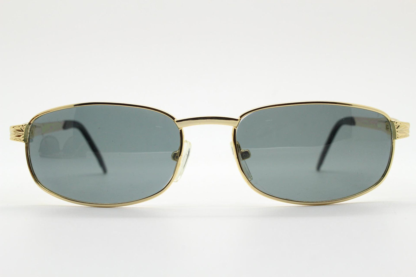 90s vintage low profile gold rectangular sunglasses. Solid metal frame in a shiny chrome finish embossed arm pattern and green lenses. NOS