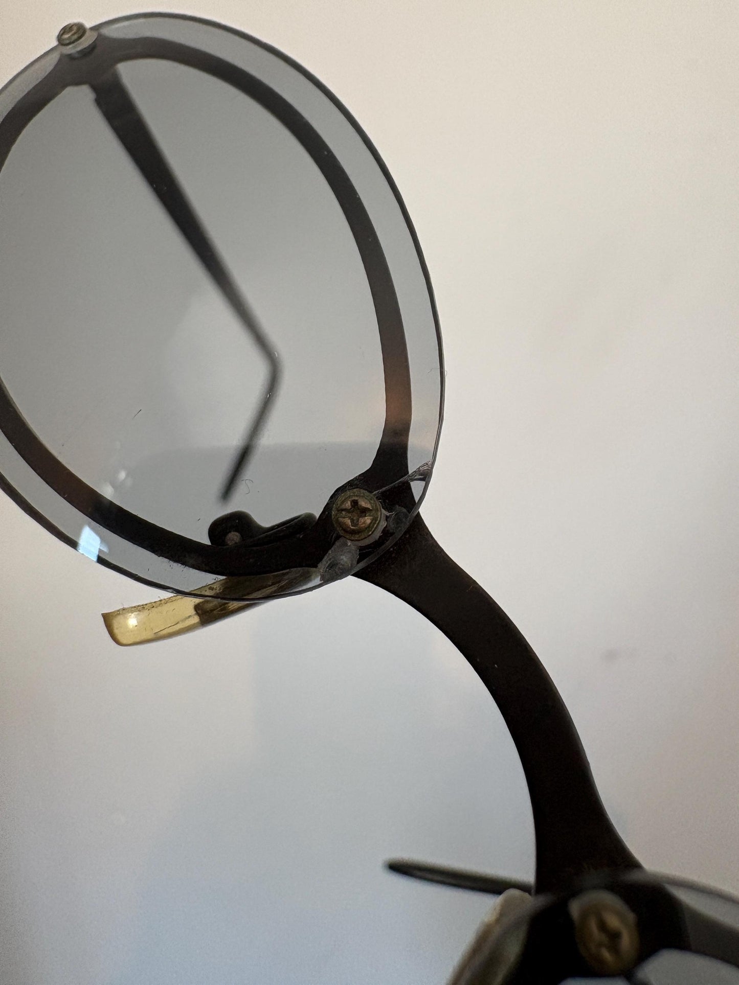 90s vintage small oval sunglasses. Minimal black metal frame with clever overlapping lens design in light tone grey. Micro. Steampunk. NOS