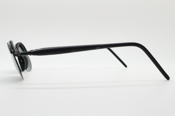 Inkognito 90s vintage small oval sunglasses. Matt finish half frame with spell out logo brow and polarising lenses. NOS