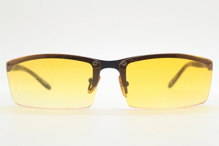 Y2K vintage half frame visor sunglasses. 2000's black brow line with light tone blazing orange rectangular curved lenses. 00's