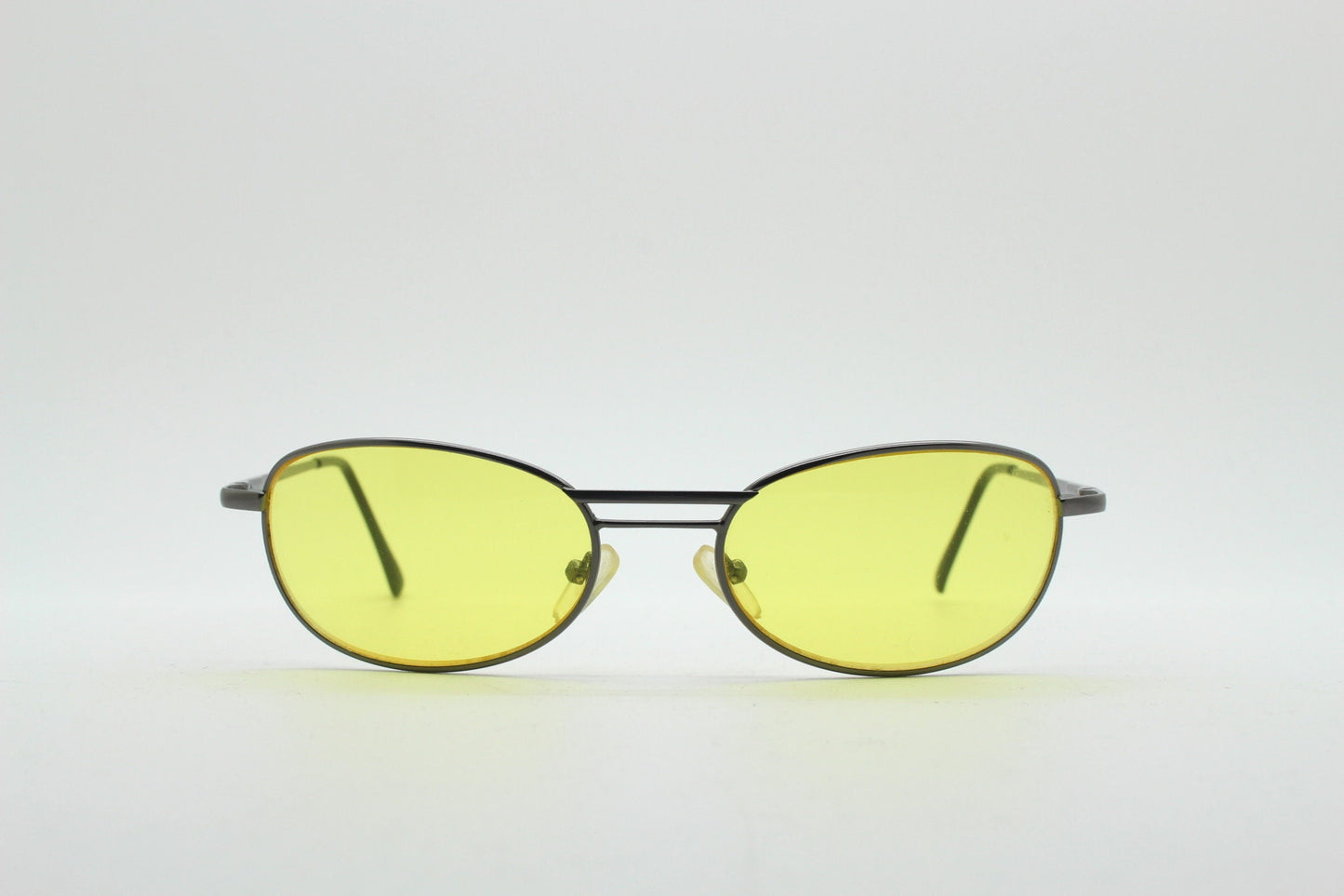 Y2K vintage small oval bug eye sunglasses. Gunmetal grey satin finish frame with blazing canary yellow lenses. Unused 2000s NOS. 90s micro