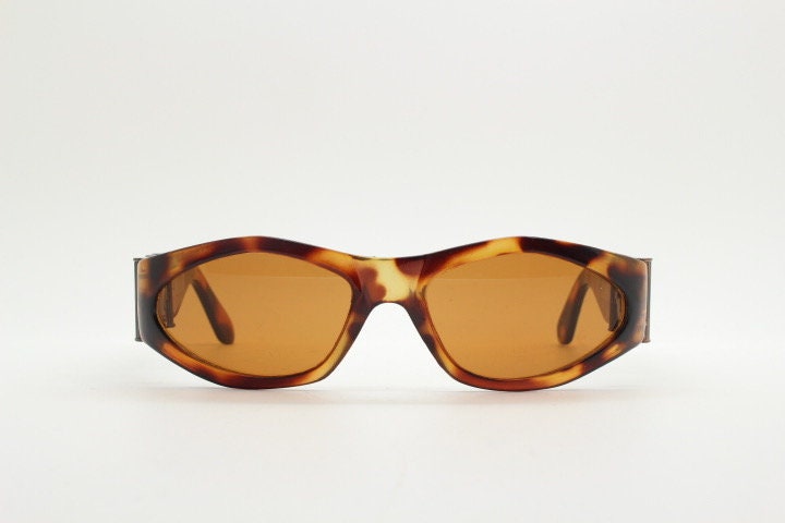 90s vintage oval sunglasses. Low profile transparent tortoise frame with massive bronze metal arm crests BNWT. Unused NOS