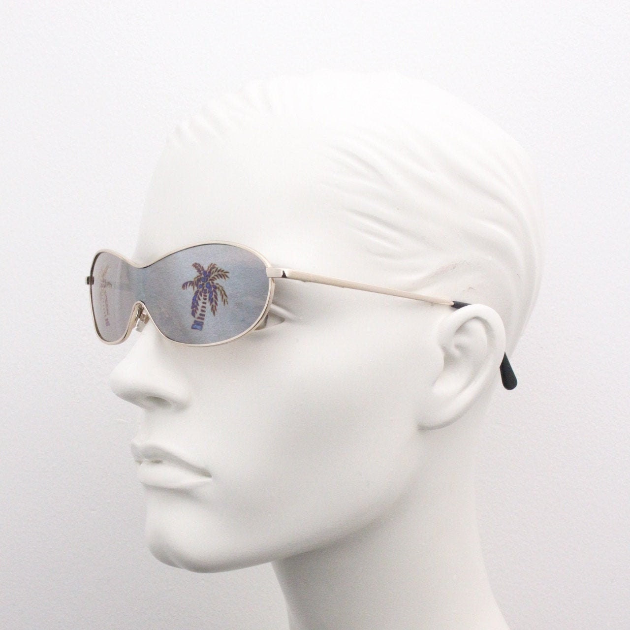 Party monster Y2K vintage visor sunglasses. Wraparound mono lens mini mask shield design with mind bending palm tree print. Unused NOS