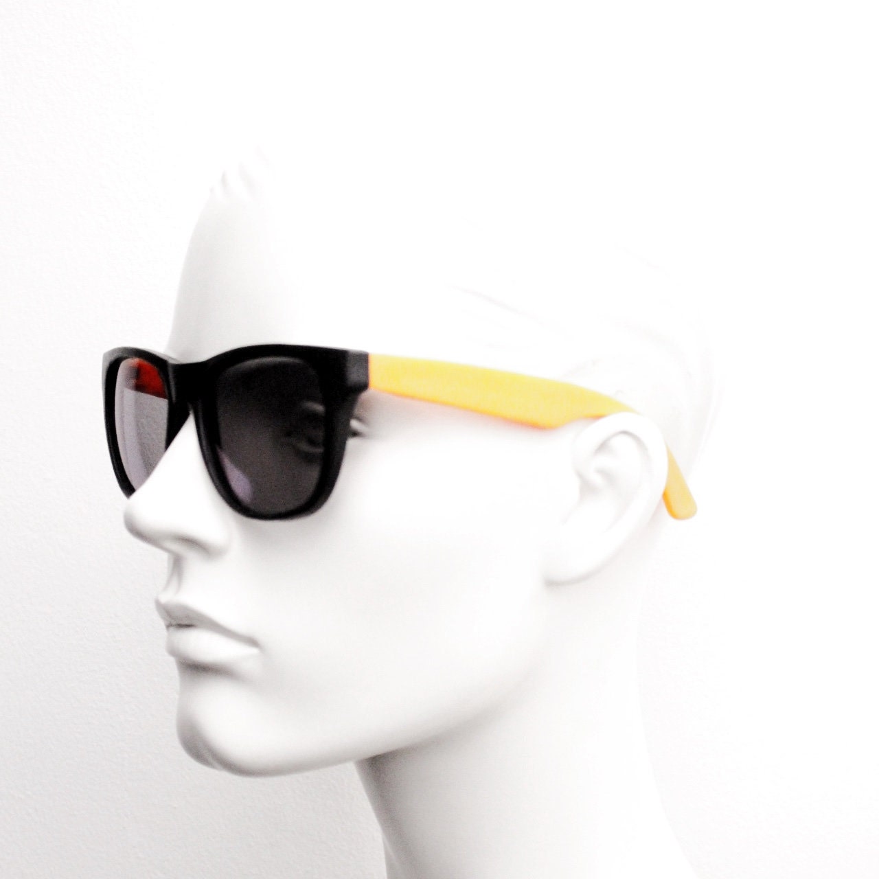 80s vintage 2 tone wayfarer style sunglasses. Matt black flexible rubber frame with orange dayglo arms. Unused NOS. Y2K fluorescent rave