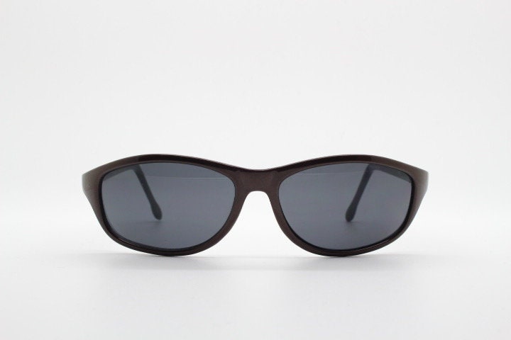 Y2K vintage wrap around shield sunglasses. Brown aerodynamic high gloss frame with black curved lenses. 2000's sport. New Old Stock 90s