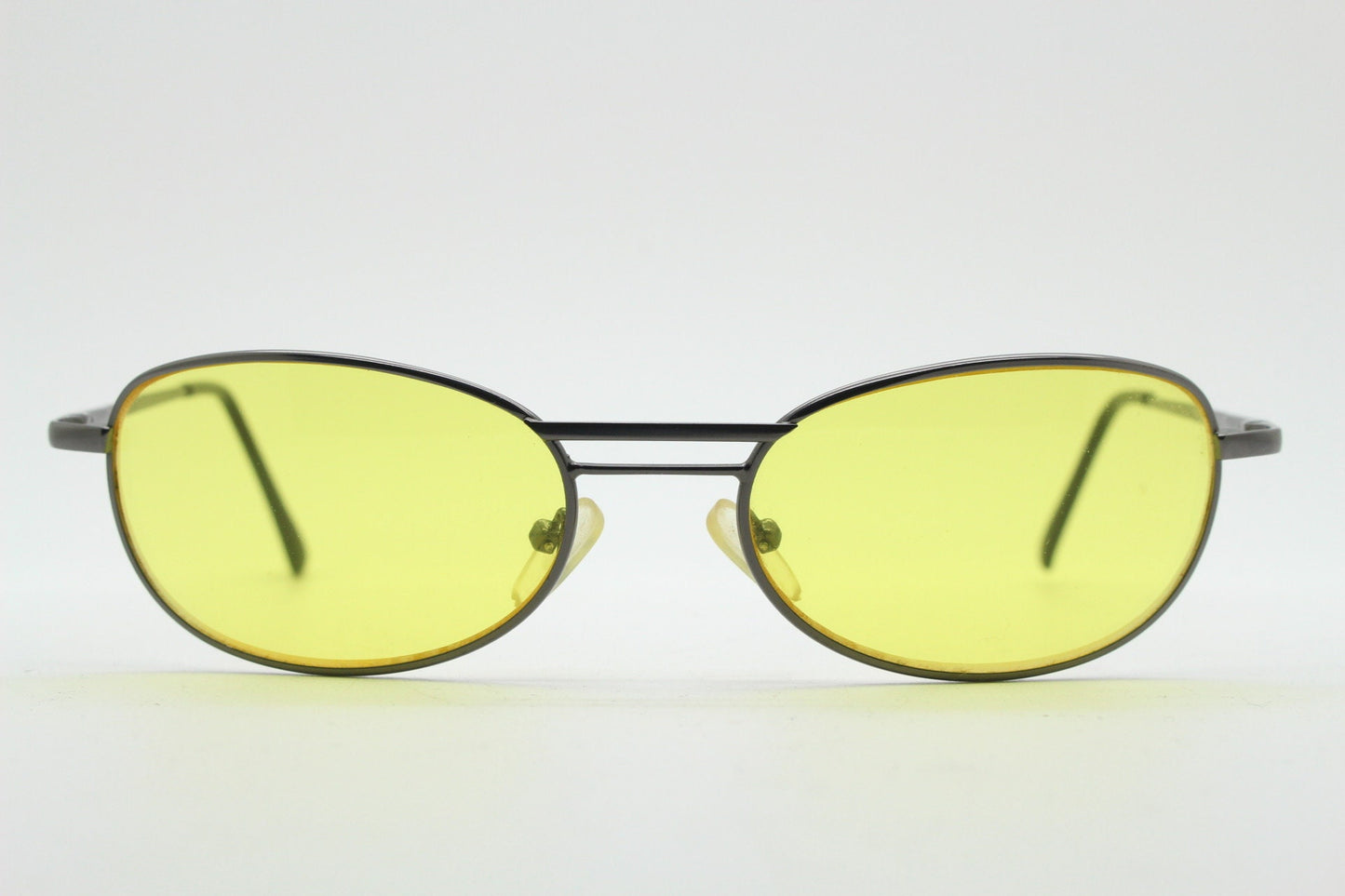 Y2K vintage small oval bug eye sunglasses. Gunmetal grey satin finish frame with blazing canary yellow lenses. Unused 2000s NOS. 90s micro