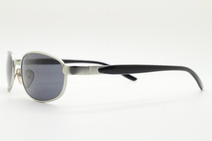 90s vintage small bug eye rectangular sunglasses. Satin finish silver frame with black gloss arms. Unused. 2000s. NOS