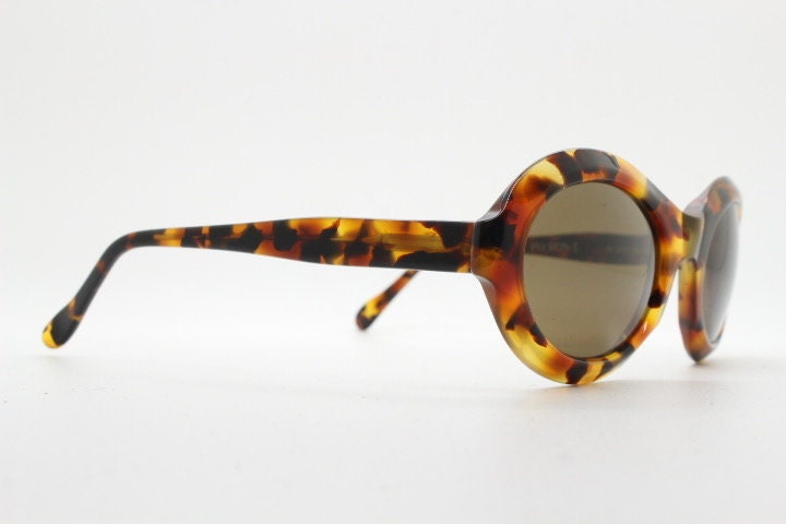 Francois Pinton Paris 90s vintage oval sunglasses made in France. Womens thick acetate frame in brown and amber tones. NOS