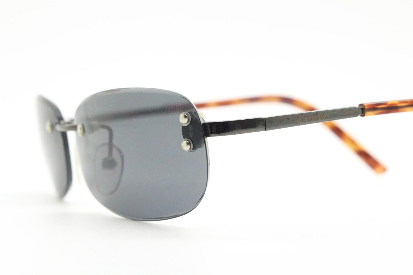 90s vintage minimal frameless sunglasses. Black rectangular lens with gunmetal grey trim and tortoise arms. Simple and effective design. NOS