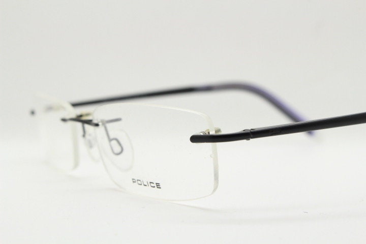 Police 90s vintage rectangular frameless eye glasses made in Italy. Minimal low profile optical frame with black satin metal trim. RX