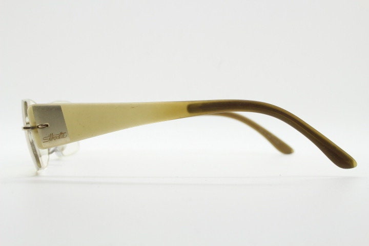 Silhouette rectangular frameless eye glasses model 7599 made in Austria. Minimal optical frame with transparent brown arms. Prescription RX