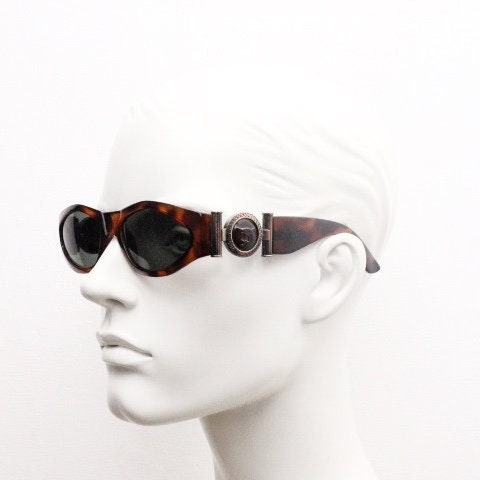 90s vintage oval sunglasses. Low profile transparent tortoise frame with massive bronze metal arm crests BNWT. Unused NOS