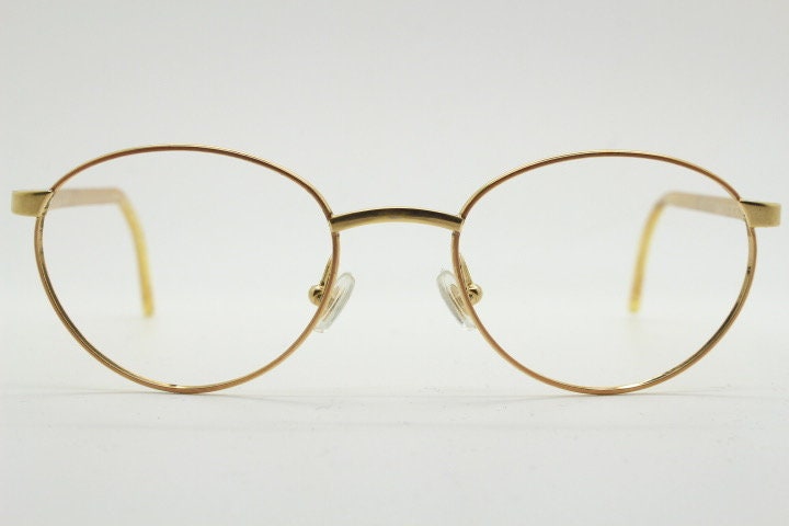 Christian Dior 90s vintage oval eye glasses made in Austria. Lustrous gold finish optical frame with CD chain link arms. Prescription RX NOS