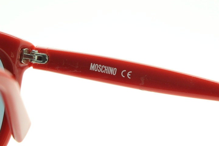 Moschino oversized Y2K vintage sunglasses. Characteristic crimson red acetate frame with cut out heart bridge. 2000s