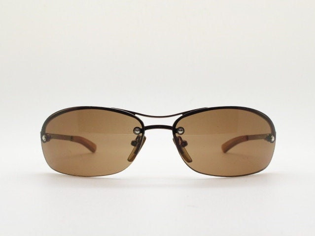 Y2K vintage oval aviator sunglasses. Metallic brown chrome half frame with mid tone curved bug eye lenses and straight arms. 2000's. NOS