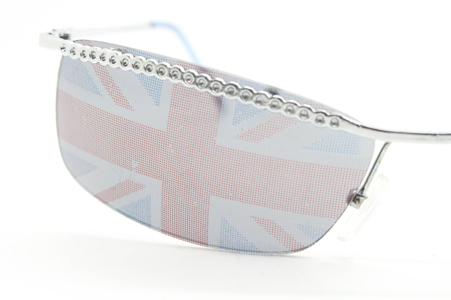 90s vintage half frame Union Jack sunglasses. Curved lens suspended on a sparkling chrome brow. Unused NOS. Brit pop girl power