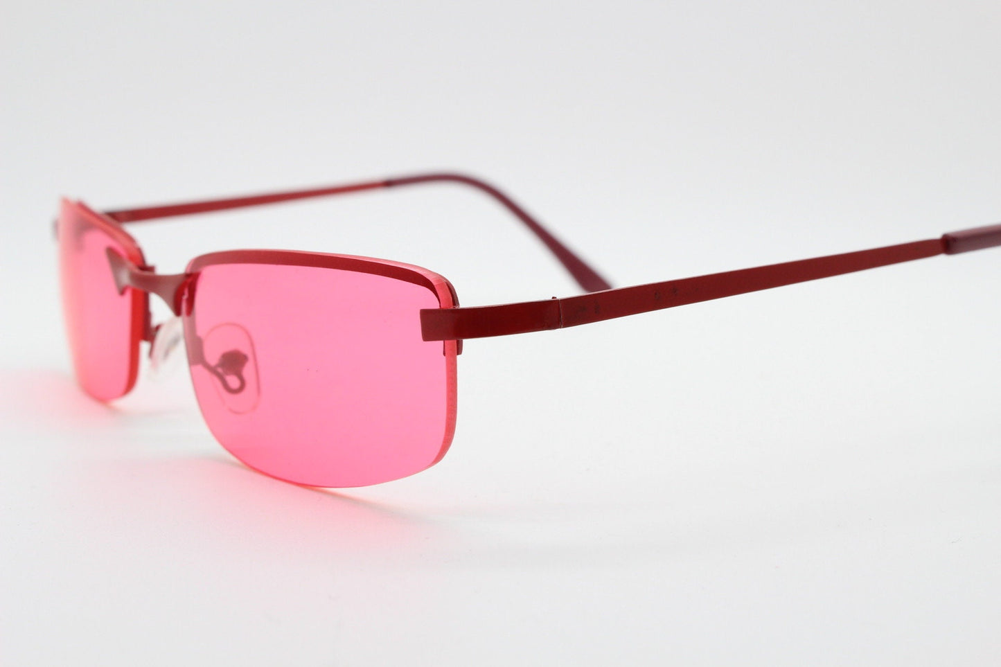 Y2K vintage half frame sunglasses with rectangular pink lenses and matching frame colours. 2000s NOS. 00's. 90s Rave
