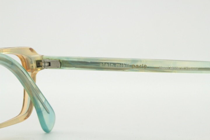 Alain Mikli rectangular eye glasses hand made in France. Low profile slim peach and blue transparent acetate optical frame. Prescription RX.