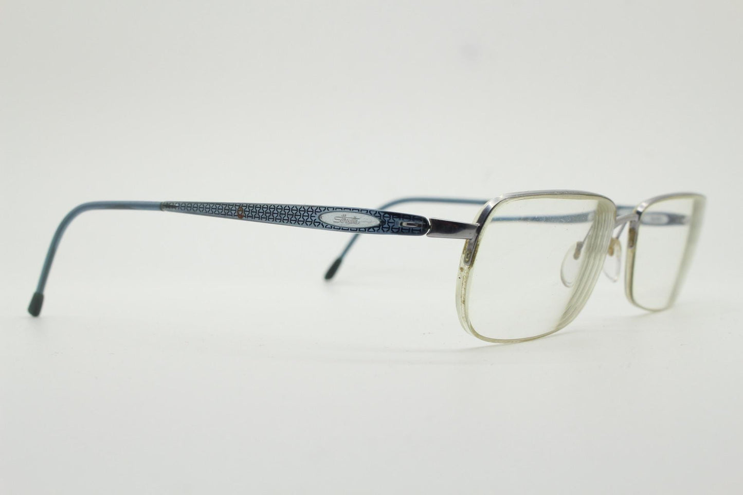 Silhouette rectangular half frame eye glasses made in Austria. Minimal brow line optical frame with patterned transparent arms. Prescription
