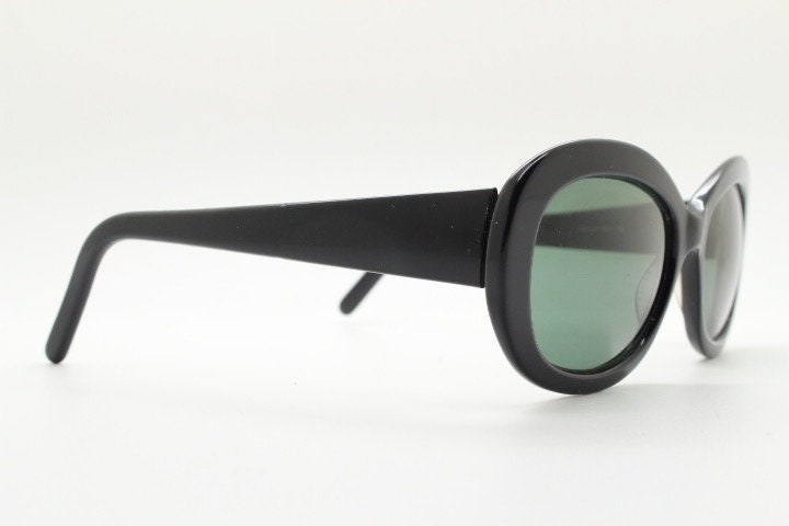 Calvin Klein vintage oval cateye sunglasses made in Italy. Womens plain black gloss thickened acetate cat eye. Classical 60s design. Y2K