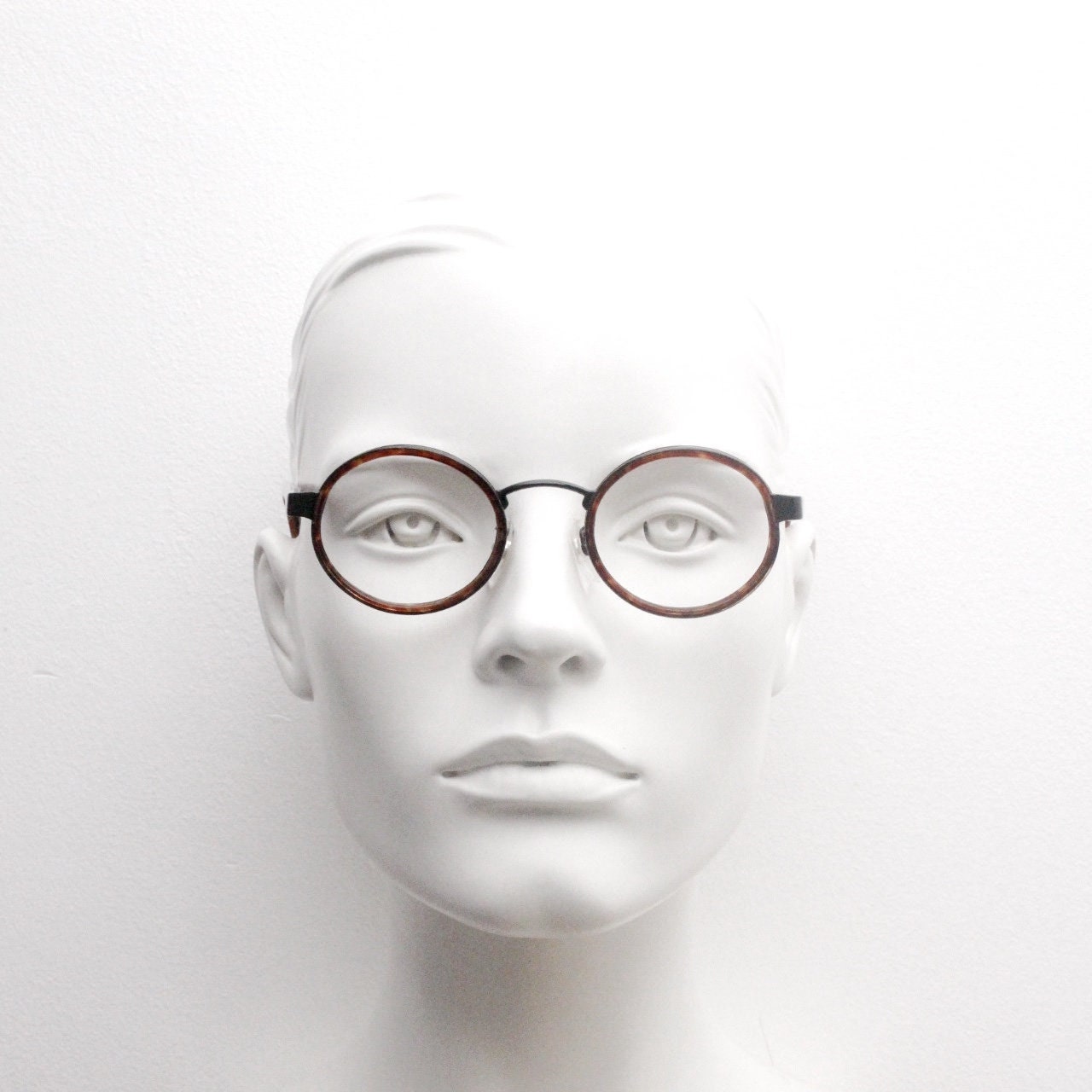 90s vintage oval glasses. Minimal slim black optical frame encasing tortoise inserts. 40s, 50s style prescription eyeglasses. RX spectacles