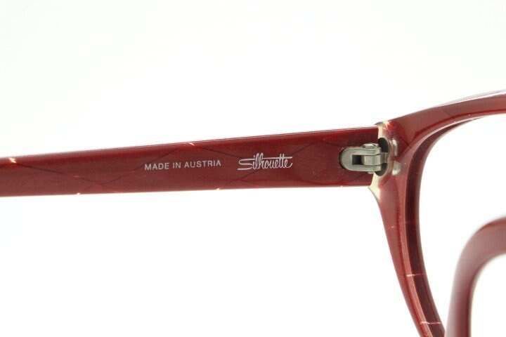 Silhouette 80s vintage oversized cat eye glasses made in Austria. Dramatic red prescription optical frame with subtle criss cross stripes RX