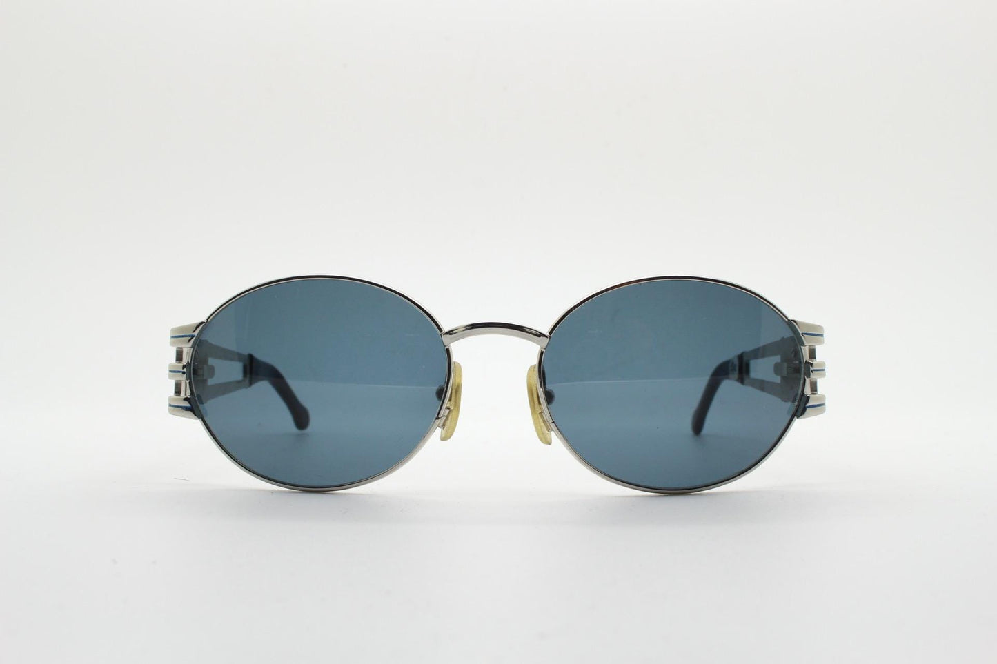 Sunsweet 90s vintage metal oval sunglasses made in Italy. Definitive ornate temple design with classical sun crests in silver chrome. NOS
