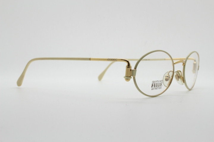 Gianfranco Ferre 90s vintage oval eye glasses made in Italy. White and gold metal tech design optical frame. Prescription RX spectacles. NOS