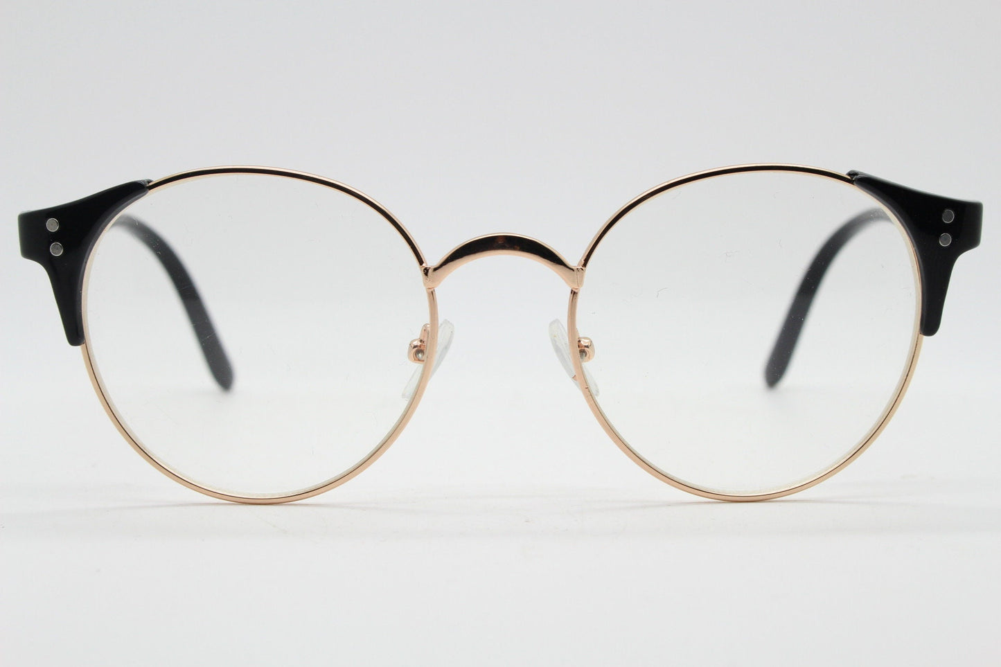 90s vintage modified cat eye glasses. Black arms with a round gold face. 40s, 50s style clear lens eyeglasses. Cateye