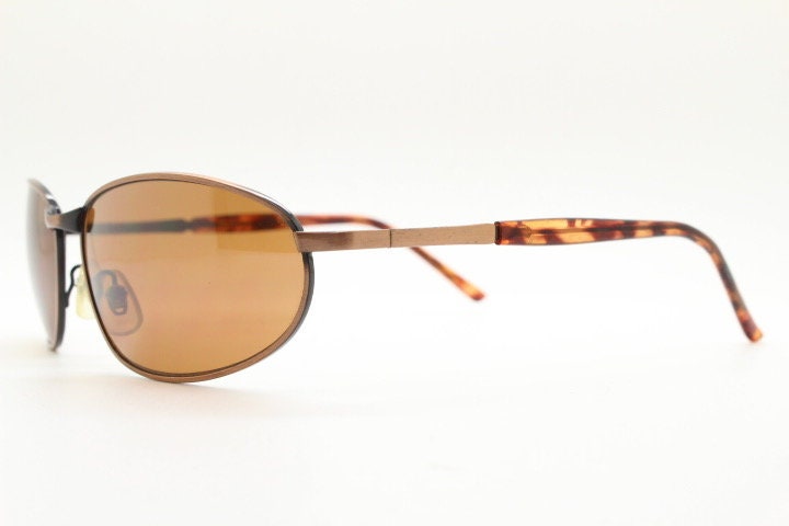 Y2K vintage small bug eye aviator sunglasses. Curved copper brushed finish solid metal frame with tortoise arms. Unused 2000s NOS