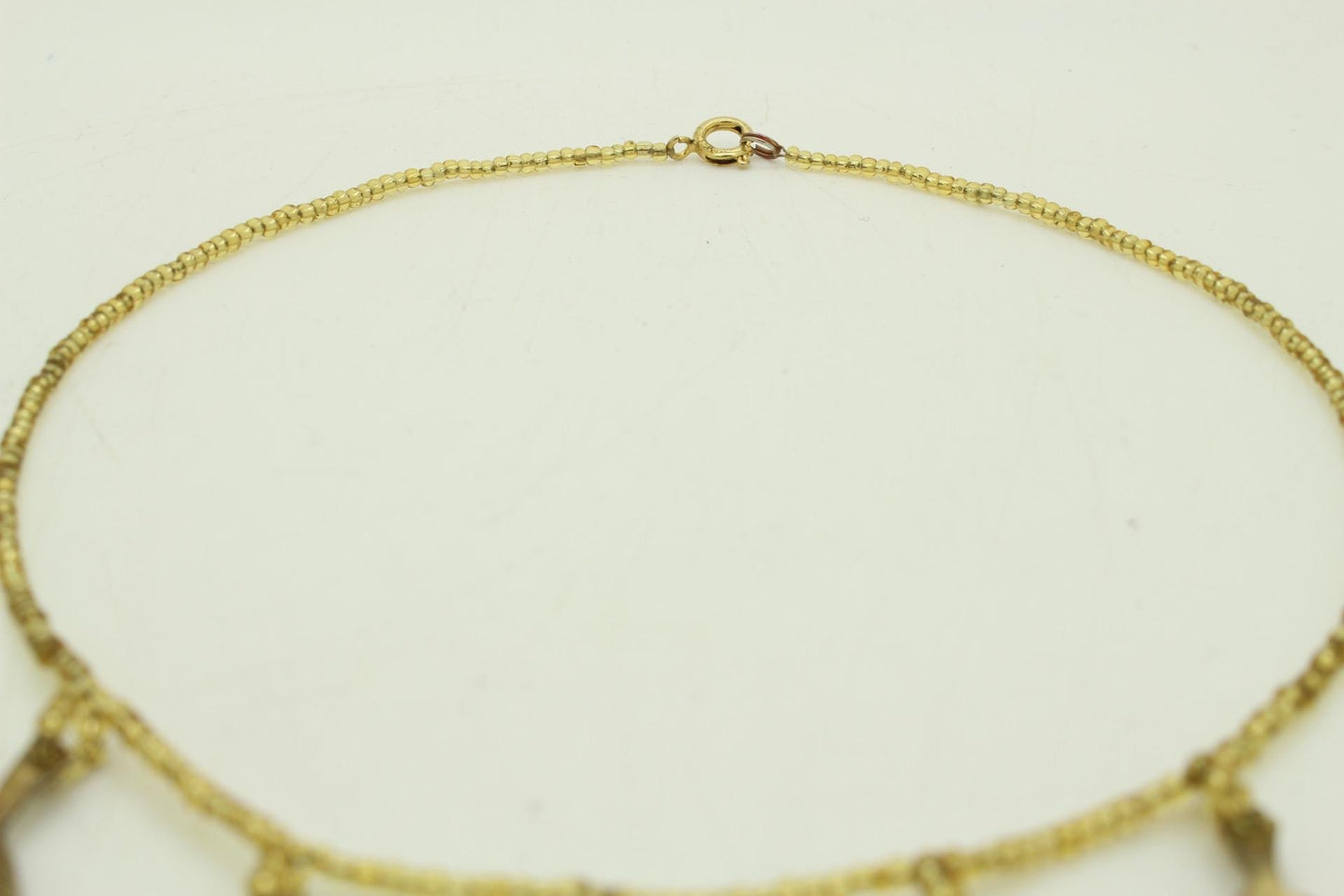 80s vintage gold beaded necklace with large dangling leaves . Charming statement piece. Country and western. Native american