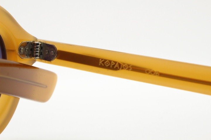 Kopajos thick framed round sunglasses. Hand made transparent amber acetate chunky frame with contrasting graduating lenses