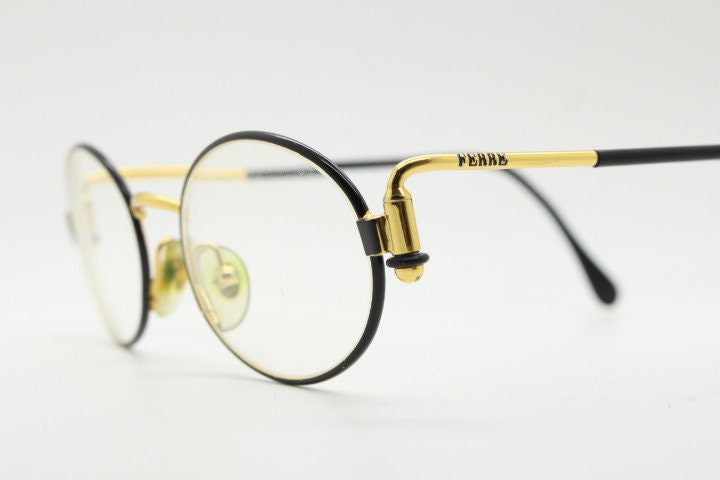 Gianfranco Ferre 90s vintage oval eye glasses made in Italy. Black and gold metal tech design optical frame. Prescription RX. NOS