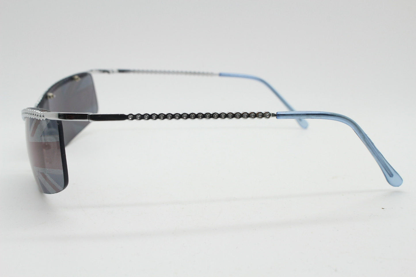 90s vintage half frame Union Jack sunglasses. Curved lens suspended on a sparkling chrome brow. Unused NOS. Brit pop girl power
