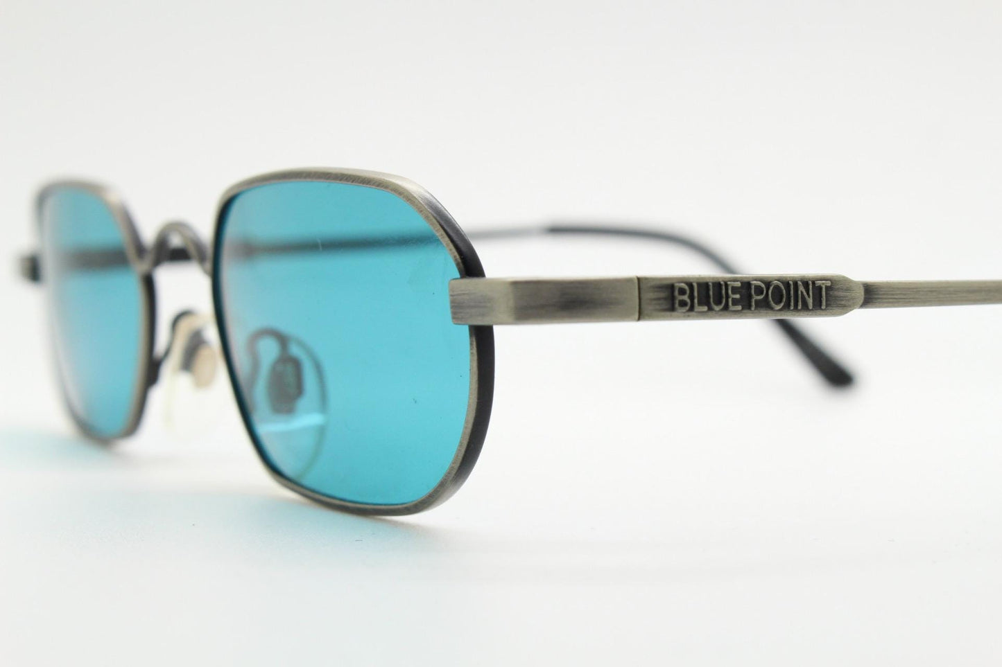 90s vintage small angular oval sunglasses by Blue Point. Low profile brushed bronze finish metal frame with turquoise blue lenses, NOS