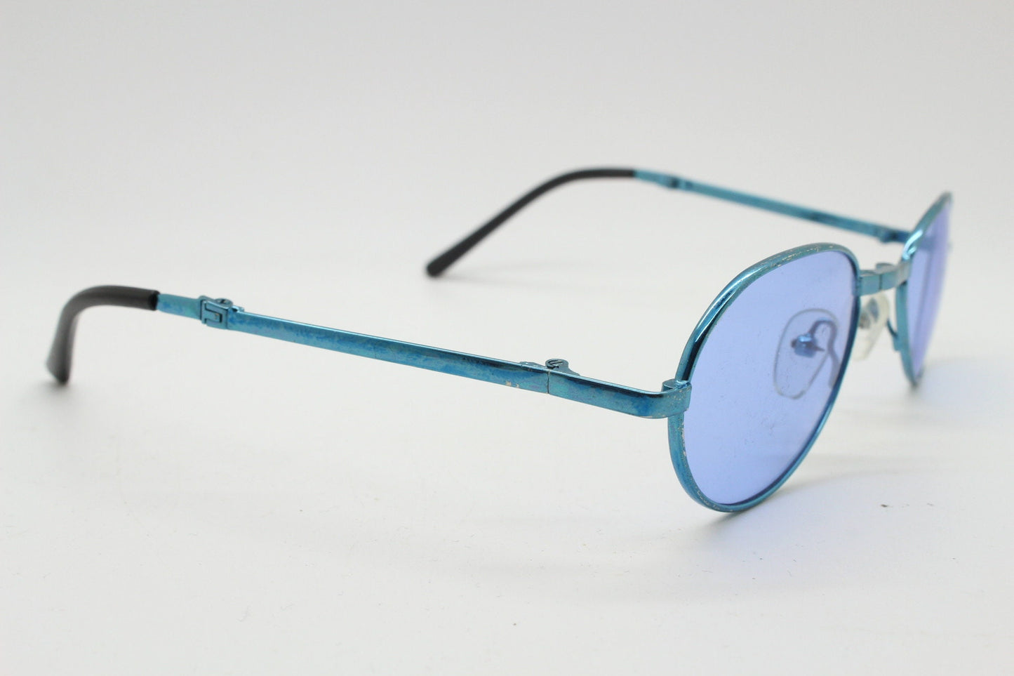 Y2K micro foldable oval sunglasses. Sky lenses in a small folding matching coloured compact frame. Folder. Rave 2000s. 90s NOS