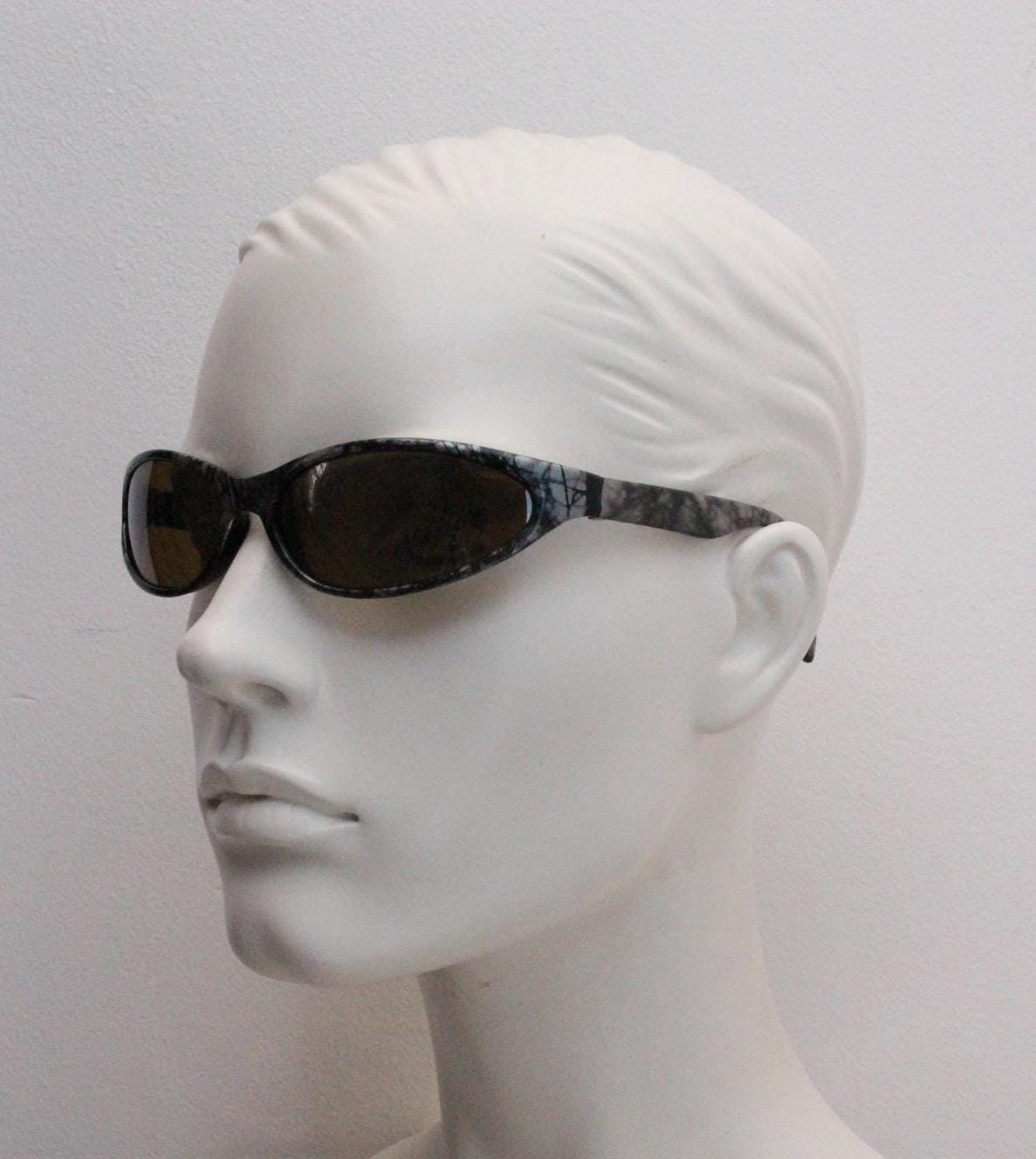 90s vintage sport shield aerodynamic sunglasses. Silver and black marble print wraparound bug eye visor with brown lenses. 2000's. Y2K