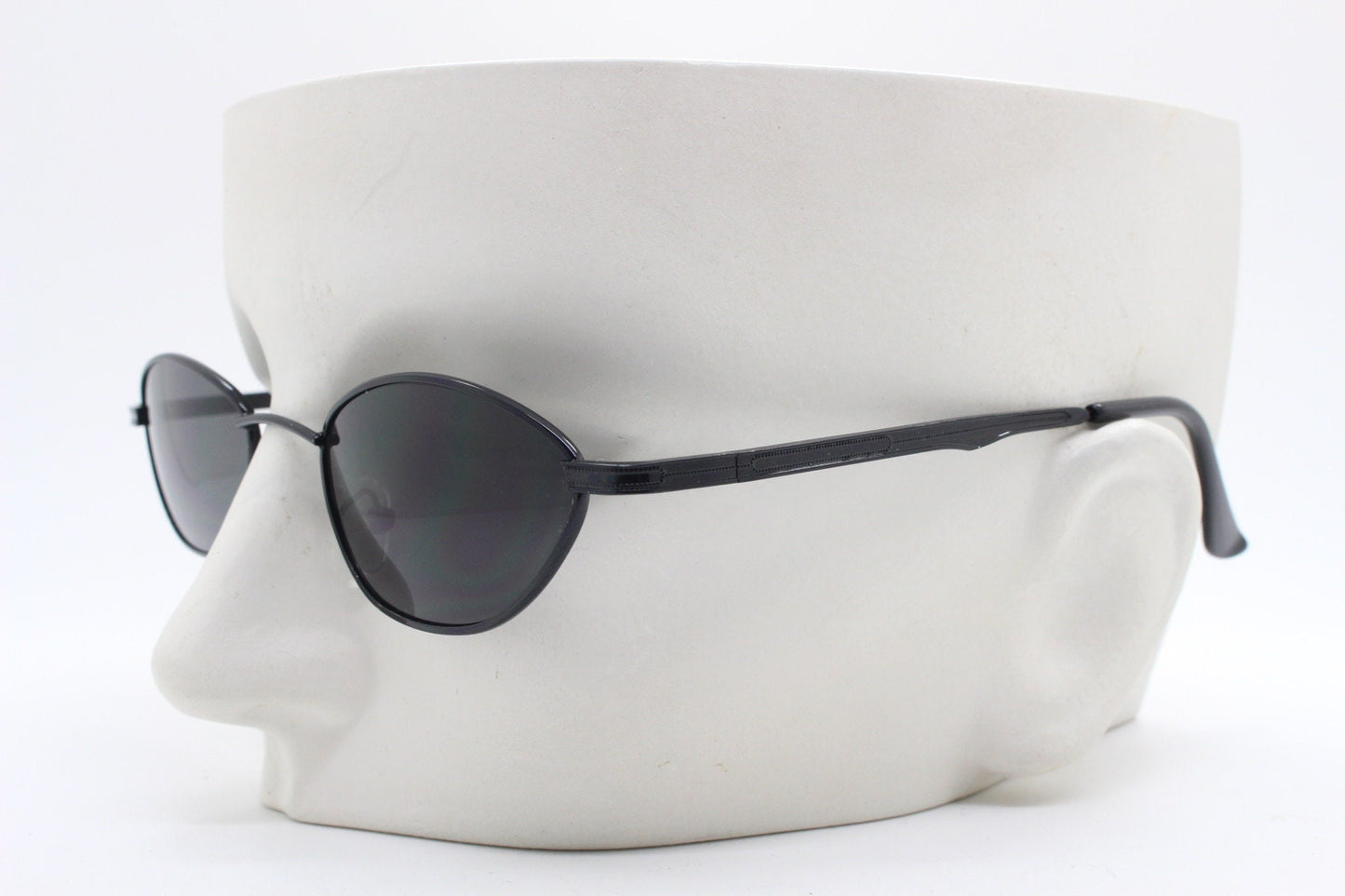 90s vintage low profile sunglasses. Minimal small black angular oval metal frame with matching lenses, Unused. BNWT