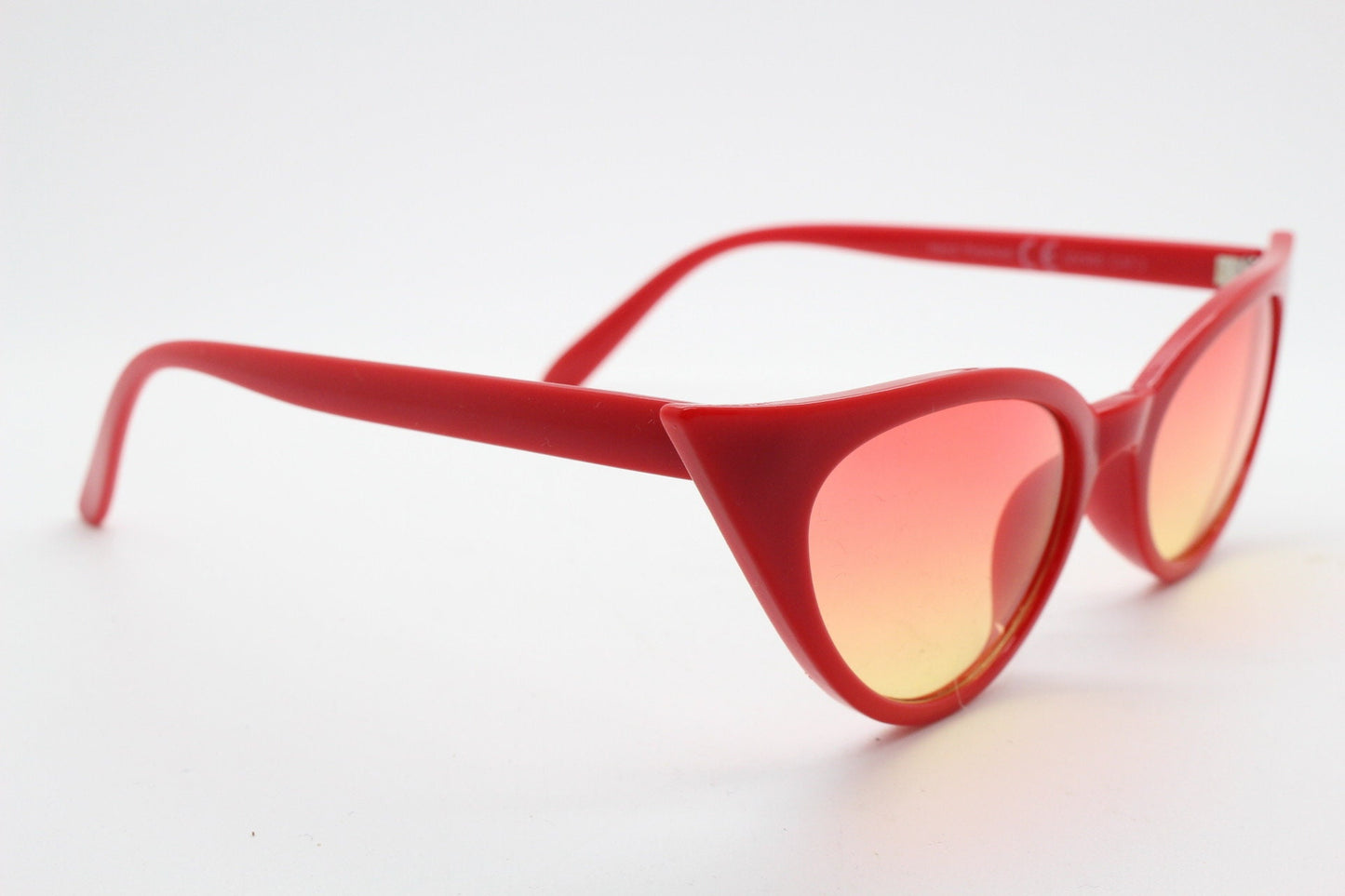 Y2K vintage pointed cat eye sunglasses. Red slender frame with graduating lenses. Womens 50s style rockabilly, pin up shades