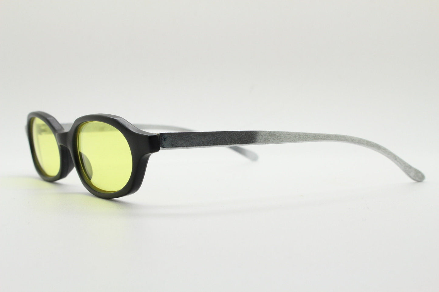 Vintage 90s oval sunglasses. Black low profile matt finish front with yellow lenses and silver chrome arms. Micro