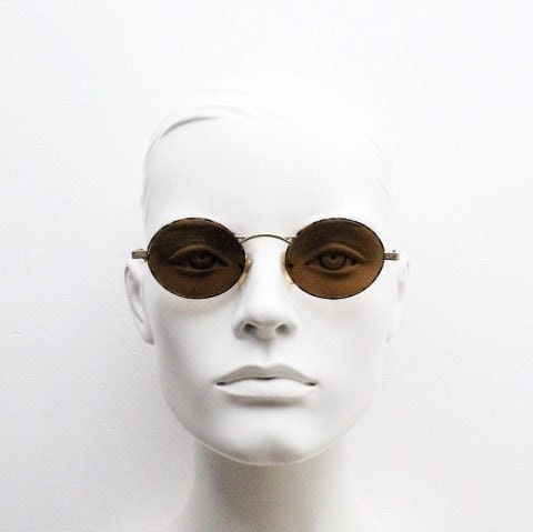 Armandos 90s vintage oval sunglasses made in Italy. Enamelled honey tortoise front with ornate tooled metal arm patterns. NOS