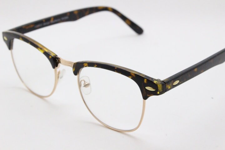 90s vintage half frame glasses. Tortoise browline eyeglasses in a gloss finish with gold underwire and clear lenses . Mens 50s, 60s design